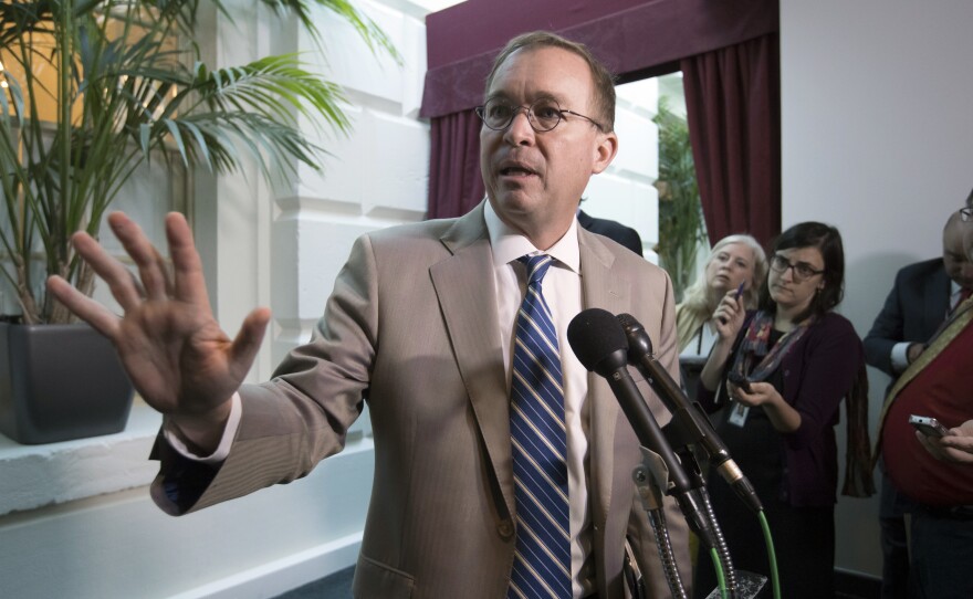 White House Budget Director Mick Mulvaney leaves a Republican strategy session in which he and Treasury Secretary Steven Mnuchin were blasted by lawmakers over President Trump's deal with Democrats.