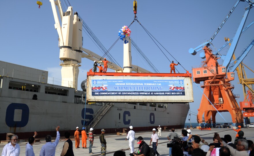 A container is loaded onto a ship during the inauguration of container service in Gwadar on May 11. China and Pakistan have agreed to build an economic corridor that will run from the Pakistani port to western China.