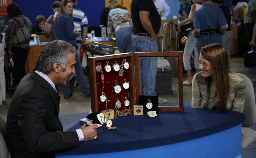 Kevin Zavian (left) appraises an American & European watch collection, in San Antonio, Texas. 