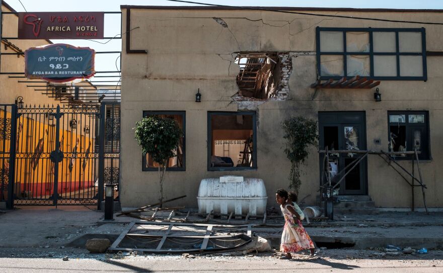 A child plays in front of a hotel damaged by mortar shelling last month in Humera, in the Tigray region of Ethiopia. On Wednesday, United Nations officials announced that they had reached a deal with Ethiopian leaders to allow humanitarian groups access to the disputed region.