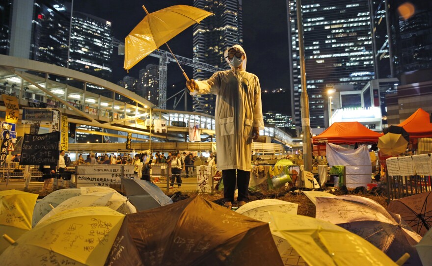 A Hong Kong protester holds an umbrella on Oct. 9, 2014, as part of the weeks of demonstrtions in the city two yeras ago. The protesters opposed the handling of the election for Hong Kong's chief executive, saying the three candidates were all hand-picked by Beijing.