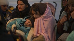 Refugees, mostly women with children, rest inside a tent after arriving at the border crossing, in Medyka, Poland on Sunday.