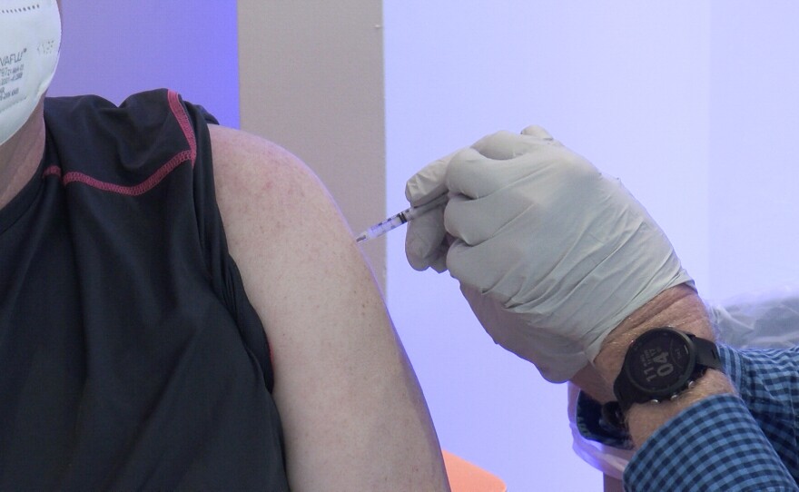 A person receives a COVID-19 vaccine at the vaccination super station at Grossmont Center in La Mesa, Calif. Feb. 2, 2021.