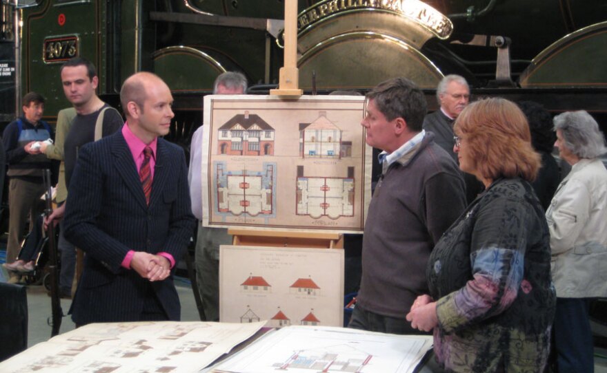 Marc Allum is intrigued by a collection of architectural plans.