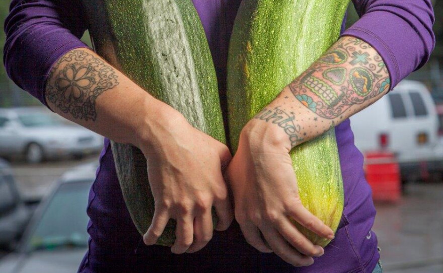 Alaska grower Brittney Kauffman holds two zucchinis she entered in a giant vegetable competition in 2013. "Alaska is just a hotbed for gardening, believe it or not," says Alaska State Fair crops superintendent Kathy Liska. "Everybody thinks that we're always under ice — no!"