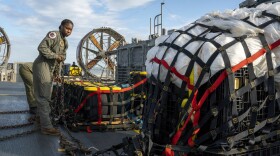 Sailors prepare material recovered in the Atlantic Ocean from a high-altitude balloon Friday for transport. The U.S. military says it has succeeded in recovering "significant debris" from a Chinese balloon that was shot down off of the South Carolina coast.