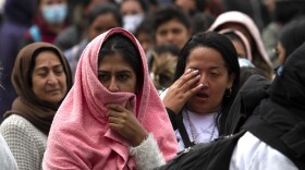 People gather near the border fence just west of the San Ysidro Port of Entry. May 10, 2023. CBP created a makeshift migrant camp in San Ysidro between the primary and secondary border walls. There are more than 400 migrants in the camp, including asylum seekers.