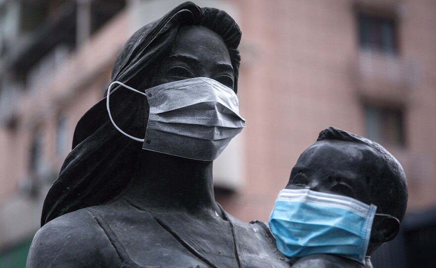 A sense of humor is still evident in Wuhan, where masks were affixed to the faces of a statue of a mother and her child.