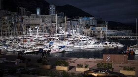 FILE - A luxury car drives along Monaco Harbor, Nov. 19, 2020.
