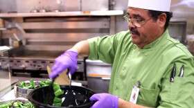 A chef at Sharp Memorial Hospital prepares a salad to be served in the hospital's cafeteria in January 2015.