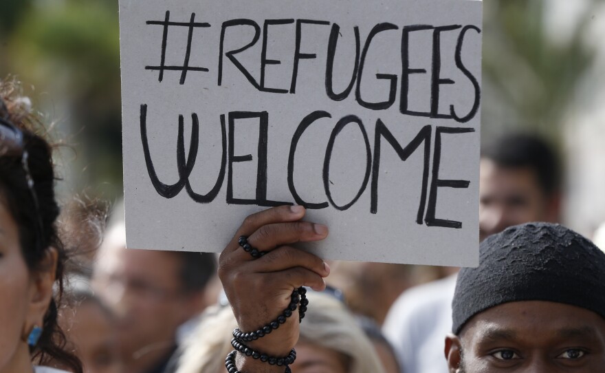 People take part in a march Saturday in support of migrants as part of the European Day of Action in Nice, in southeastern France.