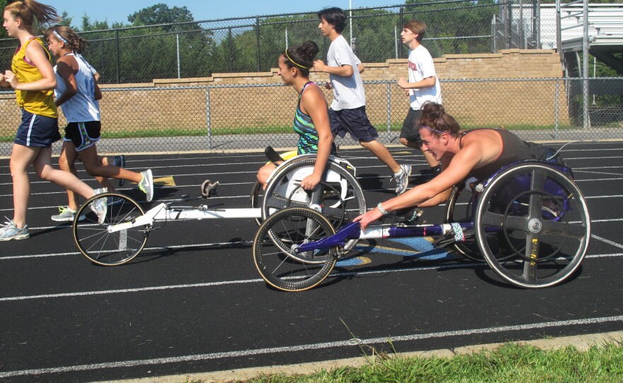 Tatyana McFadden (front), and her sister Hannah practice for the Paralympics on a high school track in Columbia, Md.