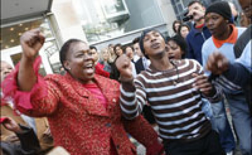 Nozizwe Madlala-Routledge (left), South Africa's former deputy health minister, sings and dances with TAC activists in Cape Town just a few days after being fired in August.