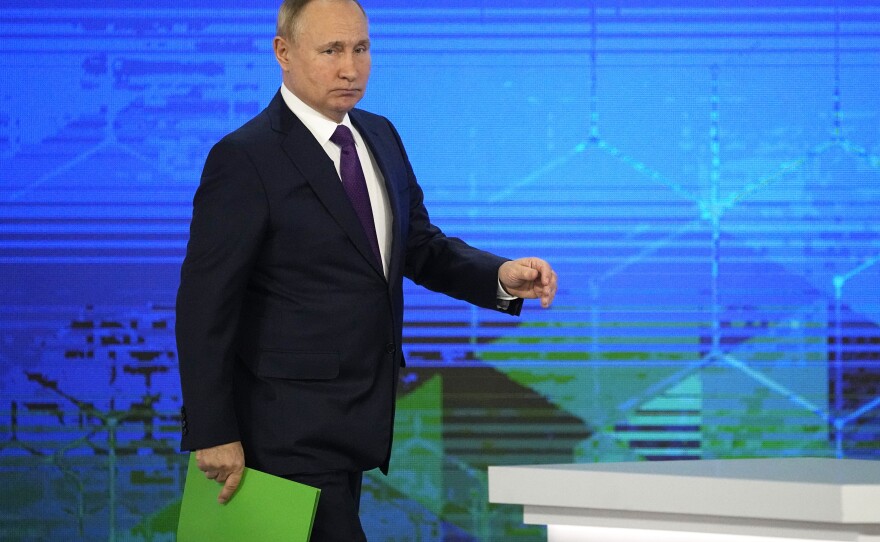 Russian President Vladimir Putin holds a news conference Thursday at the Kremlin. He said Russia wasn't planning to invade Ukraine. He blamed NATO for tensions in the region, saying the alliance should give guarantees that it will stop expanding in Eastern Europe and that it will never admit Ukraine.