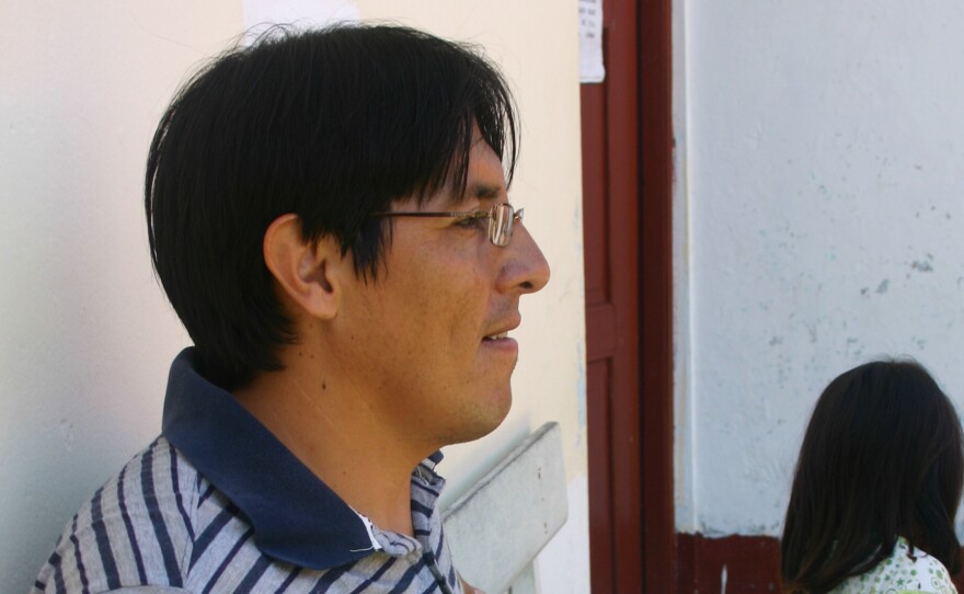 Clinic medical director Dr. Fernando Medieta holds the brother of a baby being treated for severe anemia.