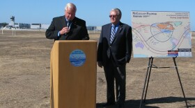 San Diego Supervisor Bill Horn and Carlsbad Mayor Matt Hall announcing the results of a feasibility study of expanding the runway at McClellan-Palomar Airport, Sept. 23, 2013. At right, a map shows how the reach of aircraft would expand to Asia if the runway were expanded 900 feet.