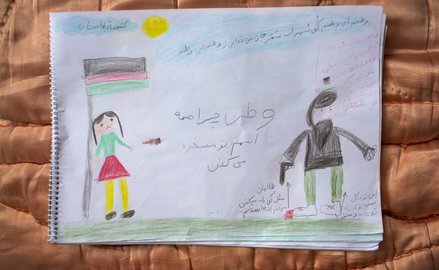 A drawing by 9-year-old Elisa Hussaini is accompanied by text explaining her feelings about Afghanistan. In the center of the page, she writes, "Homeland, why does everyone make fun of your name?" A picture of a Taliban member is on the right quashing a flower. The text says, "The Taliban are crushing the people of Afghanistan like flowers."