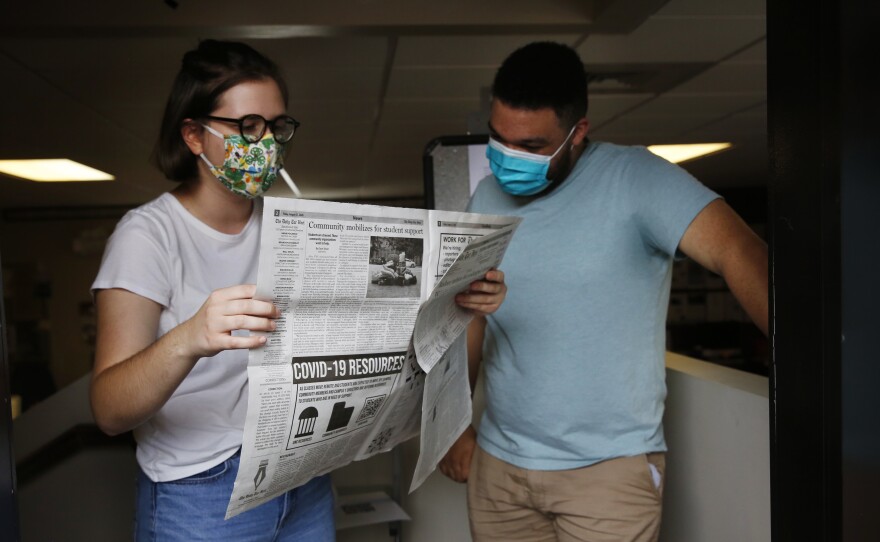 Student journalists Anna Pogarcic and Brandon Standley of UNC's Daily Tar Heel review a recent issue at their offices off campus.