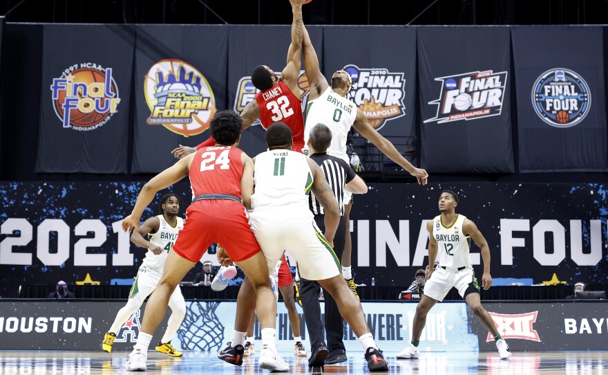 For the first time in the history of the March Madness tournament, NCAA athletes will be able to profit off their names, images and likenesses. Above, Reggie Chaney of the Houston Cougars and Flo Thamba of the Baylor Bears compete for the opening tipoff during the 2021 tournament.