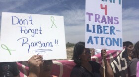 Protesters hold up signs as they gather outside a U.S. Immigration and Customs Enforcement office in Albuquerque, New Mexico, on Wednesday, June 6, 2018.