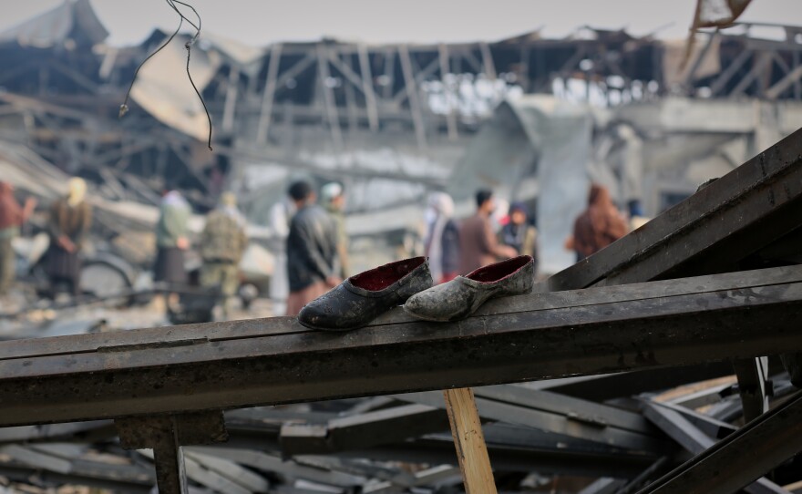 FILE - Residents and rescue workers inspect the site of an airstrike at a drug rehabilitation hospital in Kabul, Afghanistan, March 17, 2026.