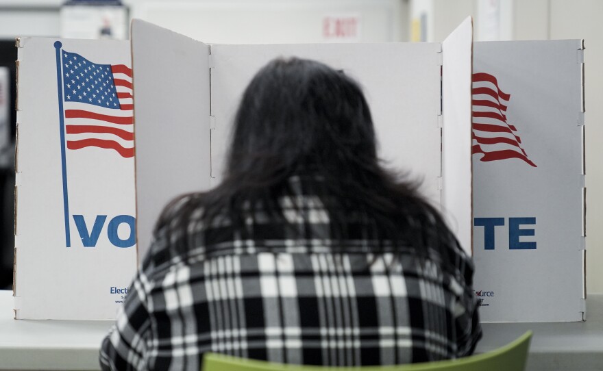 A person marks their ballot at a polling place in Falls Church, Va., during early voting for the 2024 election.