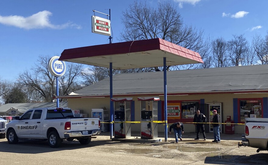 Law enforcement personnel work at the scene of a shooting Friday in Arkabutla, Miss. Six people were fatally shot in the small town in rural Mississippi and authorities said they had taken a suspect into custody.