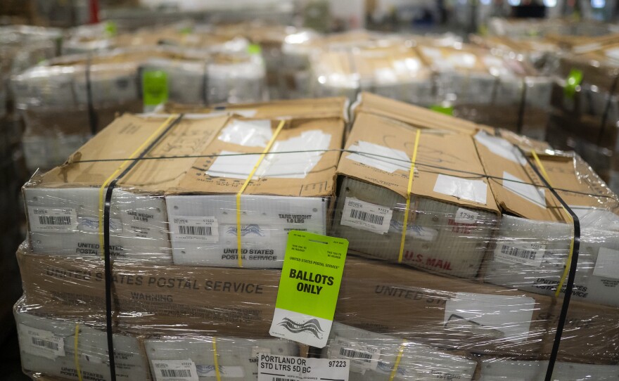 Pallets filled with Washington and Oregon mail-in ballots fill an unloading area at a U.S. Postal Service processing and distribution center on Oct. 14, 2020, in Portland, Ore.