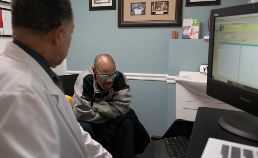 Norman Hughes talks with Dr. Chapman during an appointment.
