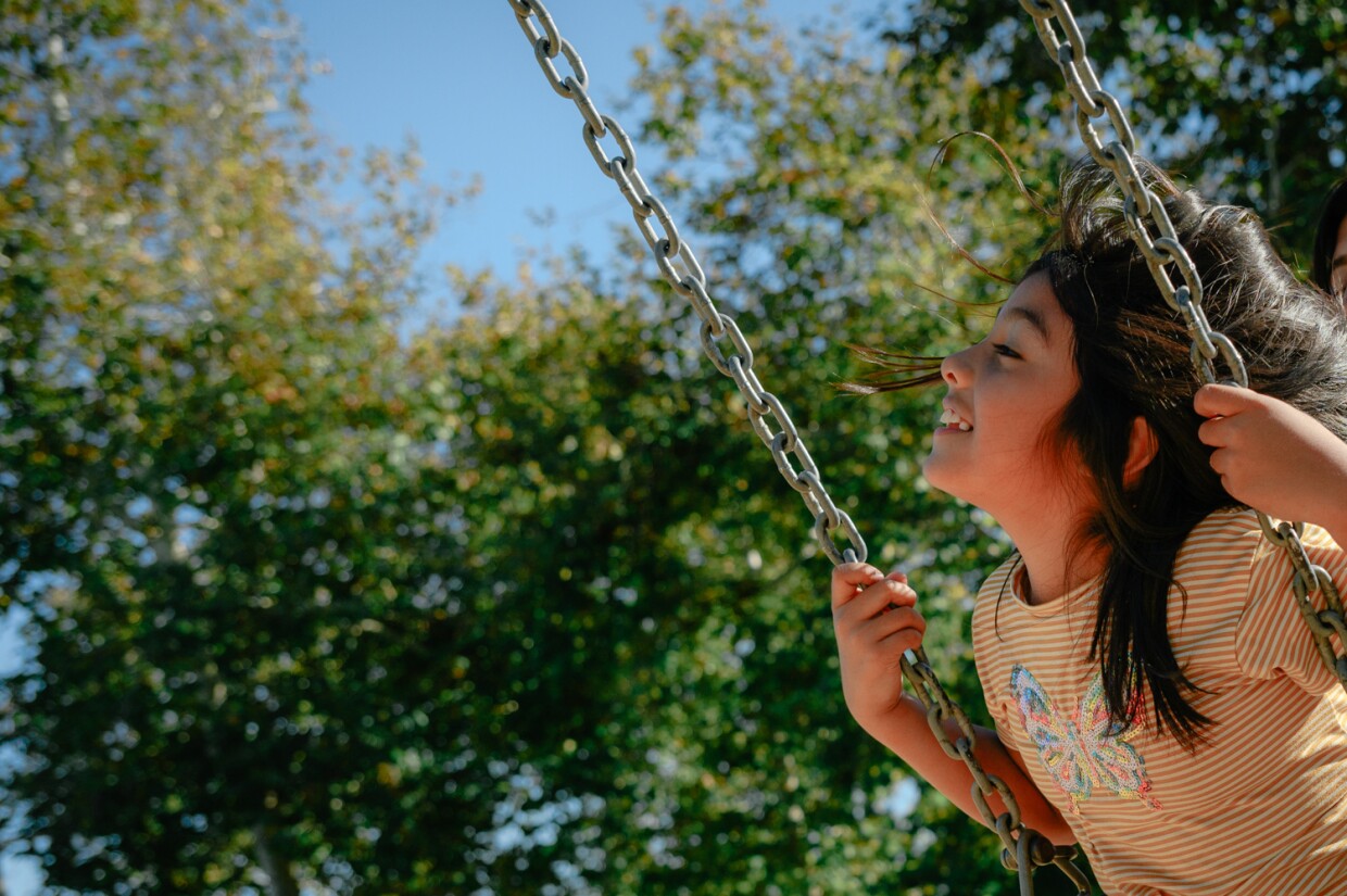 Valentina, 8, enjoys a warm afternoon on the swings at Hilltop Park in West Chula Vista on Oct. 31, 2023.