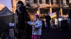 A woman walks with a child in Kiev's Independence square.
