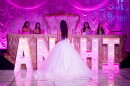 Anahi Sareñana talks to her friends while on stage during her quinceañera at the Factory of Dreams hall in Chula Vista, May 31, 2026.