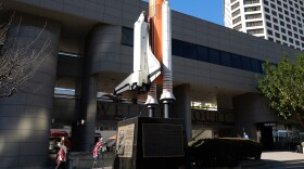 A wreath is left at a bas-relief bronze memorial and space shuttle Challenger memorial in the Little Tokyo district of downtown Los Angeles, Jan. 28, 2016.