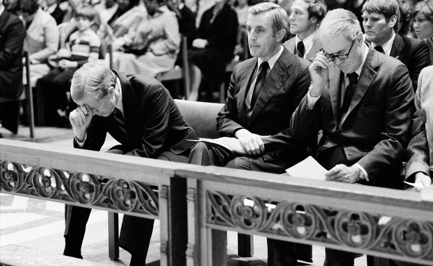 President Jimmy Carter (left) bows his head during a prayer service at Washington Cathedral on Nov. 15, 1979, for the hostages being held at the U.S. Embassy in Tehran, Iran. Vice President Walter F. Mondale (center) and Secretary of State Cyrus Vance are to his left.