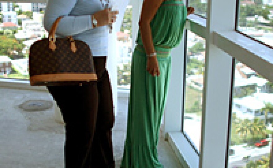 Before a condo auction this past summer, real estate agent Maggie Oertel-Ayguen (left) showed Rocio Marquez around a condo in Miami, Fla.