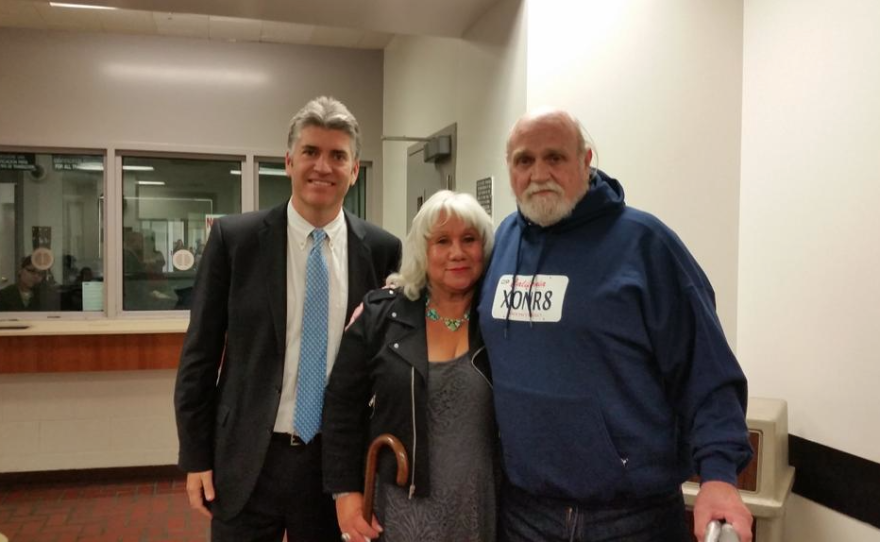 Michael Hanline poses with his wife, Sandee Hanline, after posting bail Nov. 24, 2014 at Ventura County Superior Court. He wears a sweatshirt with the image of a California license plate and the letters "XONR8," representing the word "exonerate." A judge ordered Hanline be released from prison because prosecutors said they were no longer sure he killed Ventura resident J.T. McGarry 34 years ago. Hanline was serving a life sentence for the murder.