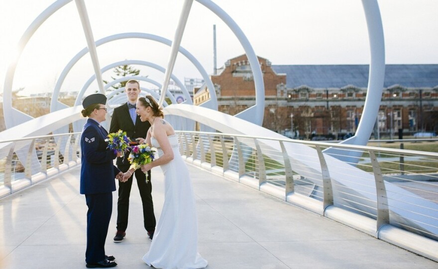 Michelle Sharp (left) and Megan Huff have their ceremony along a unique bridge in Yards Park near the Navy Yard.