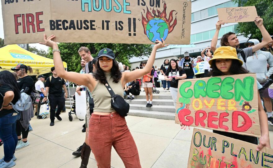 Youthful activists hold signs while participating in a Climate Strike rally on September 15 in Los Angeles.