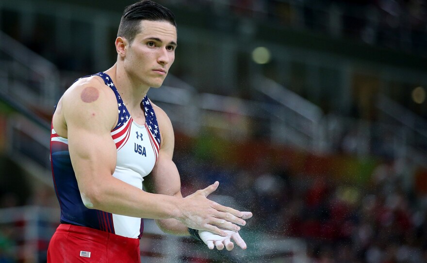Alexander Naddour, of the U.S. men's gymnastics team, bears the circular mark of cupping on his right arm as he prepares to compete on the pommel horse at the Rio de Janeiro Olympics on August 6.