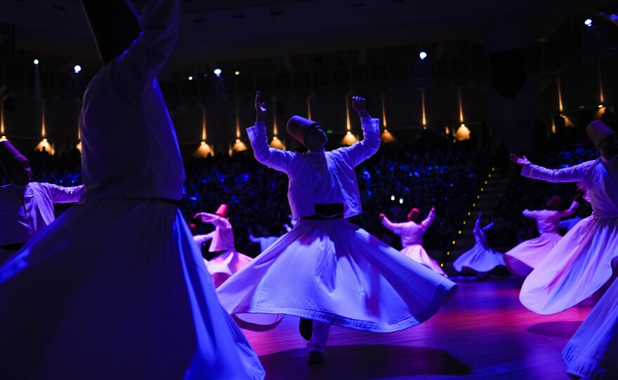 Whirling dervishes of the Mevlevi order perform during the ceremony.
