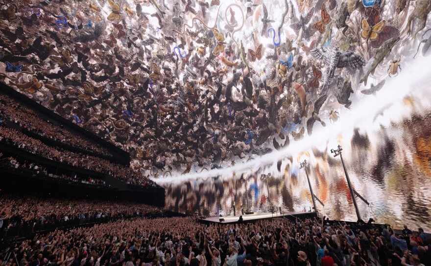 Es Devlin's <em>Nevada Ark</em>, a digital rendering of stone carvings of 26 local species that are threatened for extinction, graces "With or Without You" at the end of the show.