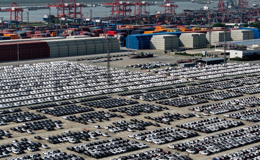 China is aiming to become a global automotive powerhouse, particularly when it comes to electric vehicles. Here, cars wait to be loaded onto a ship at a port in Nanjing.