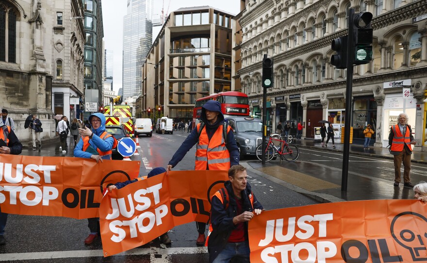 Just Stop Oil protesters block the roads at a major intersection on Thursday in London, England, the latest in its series of public demonstrations.