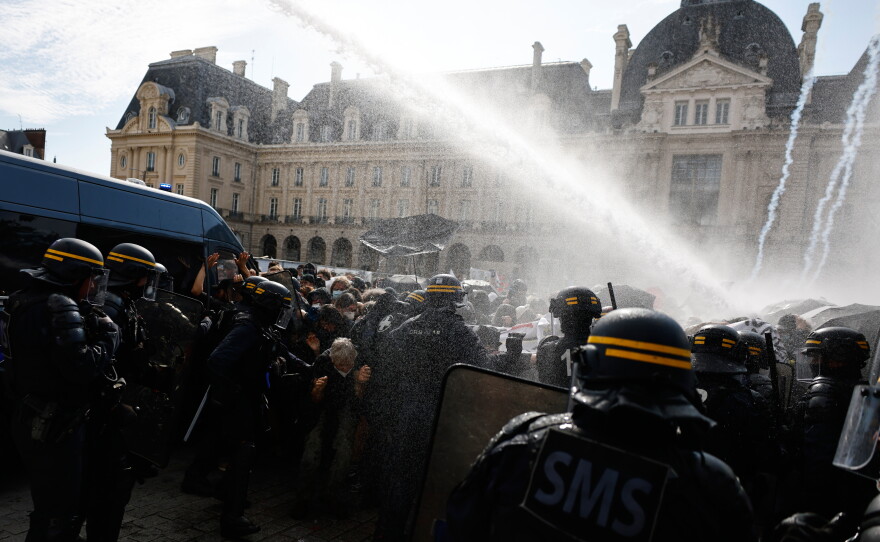 Riot police use a water cannon as they face students during a protest against under-resourced schools, in Rennes, western France, Tuesday.