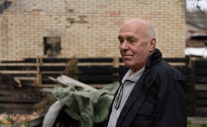 Moshchun resident Mykola Kostenko visits his home after it was badly damaged.