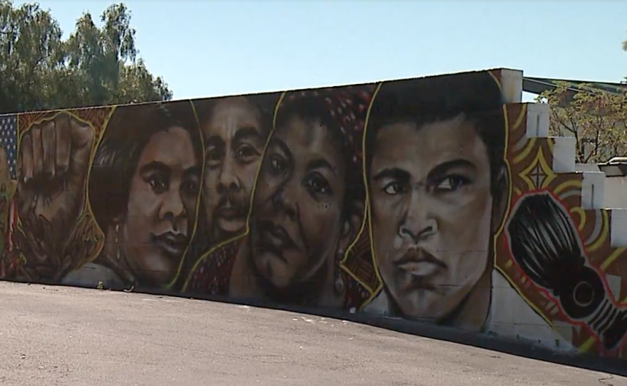 A mural at Gentry's Beauty & Barbershop Headquarters on Imperial Avenue in San Diego features leaders including Muhammad Ali and Maya Angelou.