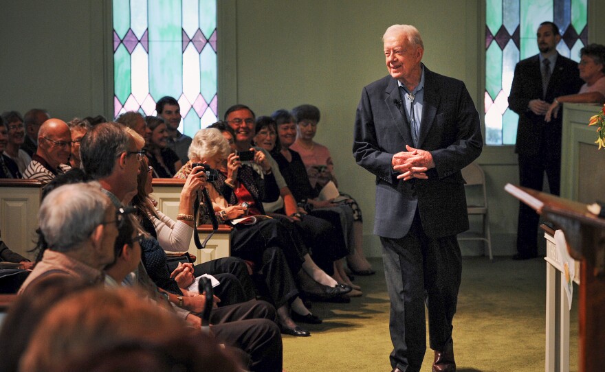 Former President Jimmy Carter greets worshippers at Maranatha Baptist church in Plains, Ga., on Oct. 10, 2010.
