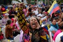 A woman screams during a government-organized event to watch former President Nicolas Maduro and first lady Cilia Flores appear in a New York court on a screen in Caracas, Venezuela, Thursday, March 26, 2026.