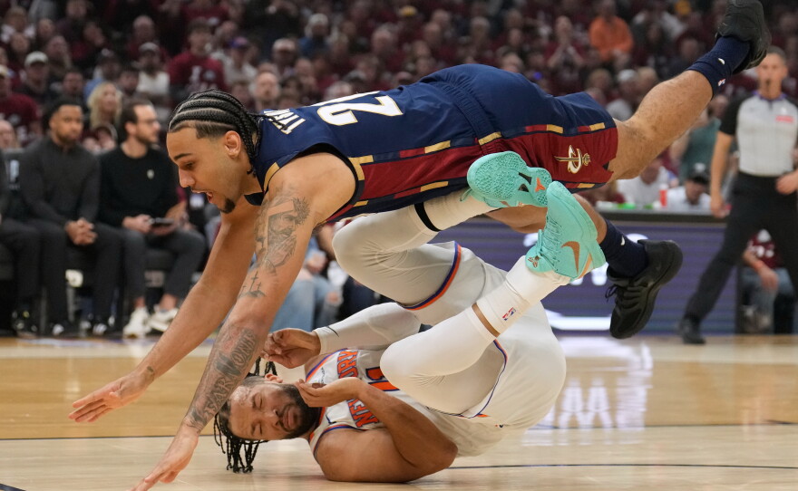 Cleveland Cavaliers guard Jaylon Tyson (20) collides with New York Knicks guard Jalen Brunson (11) during the first half of Game 4 in the Eastern Conference finals NBA basketball playoffs series in Cleveland, Monday, May 25, 2026.