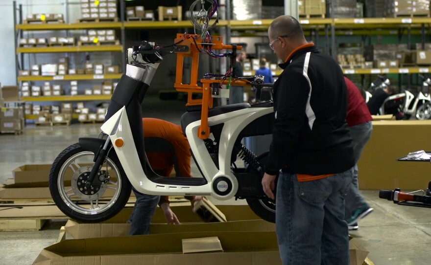 Workers at Mahindra's Ann Arbor, Mich., factory load up a new GenZe for shipping to the initial markets of the San Francisco Bay Area and Portland, Ore.